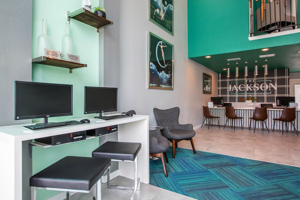 Modern lounge in The Jackson with computer workstations, stylish chairs, and wall art
