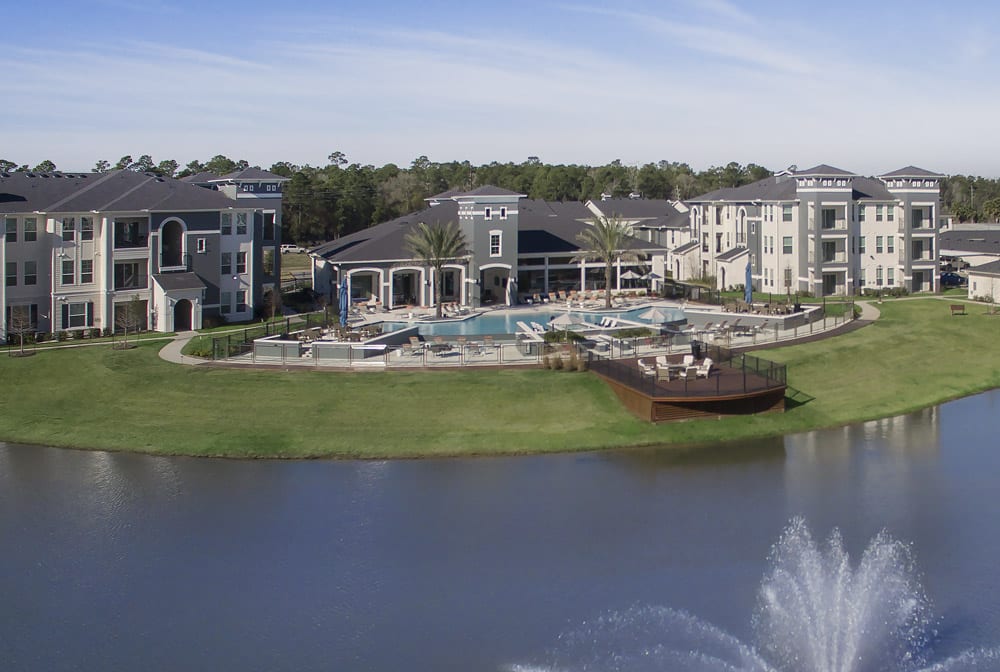 The Parkway on Westlake complex with a pool area, surrounded by a pond with a water fountain in front.